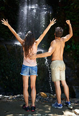 Image showing Success, waterfall or back of couple in nature or journey on outdoor trekking adventure together. Excited, victory or proud people cheering on holiday for hiking exercise goals, travel or wellness