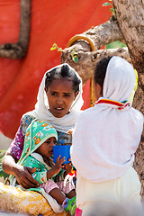 Image showing Orthodox christian Ethiopian people behind famous rock-hewn church, Lalibela Ethiopia people diversity,