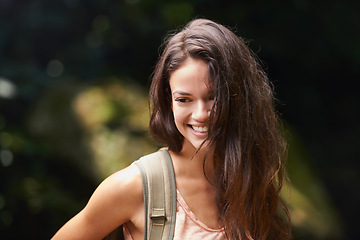 Image showing Hiking, backpack or happy woman in nature, woods or wilderness for trekking or outdoor adventure with bag. Smile, relax or hiker walking in natural park or forest for exercise or wellness on holiday