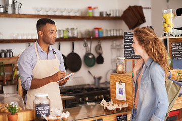 Image showing Woman, cafe and barista with order at counter for purchase, shopping and lunch at coffee shop. Female person, small business and waiter with notepad for discussion, writing and customer service