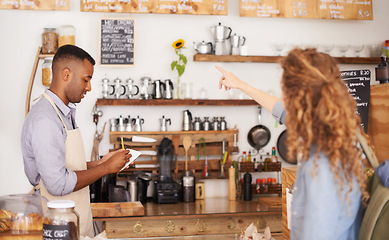 Image showing Barista, cafe and customer service with drink, order and menu for choice, writing and helping. Small business owner, cashier or waiter listening to person for decision on sale and coffee shop startup
