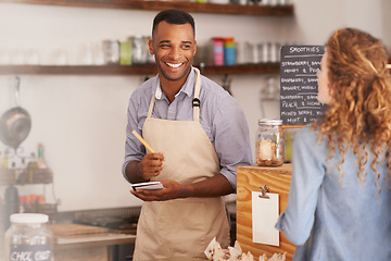 Image showing Customer, cafe and waiter with order at counter for purchase, decision and buying lunch at coffee shop. Woman, small business and male barista with notepad for service, writing and choice on menu