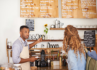 Image showing Woman, coffee shop and waiter with pointing at menu for customer, purchase and decision in cafe. Barista, small business and lady in restaurant with help, shopping and choice for lunch order