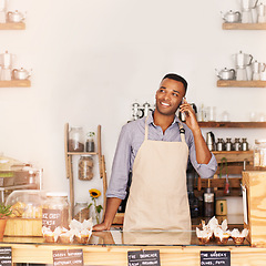 Image showing Planning, smile and phone call with black man in coffee shop for communication, networking or service. Cafe, restaurant and thinking with happy young small business owner or vendor working in bakery