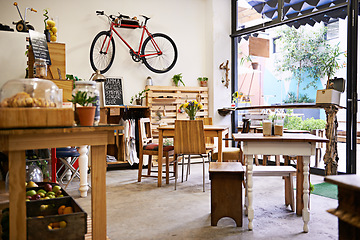 Image showing Interior, bike on wall of empty coffee shop with tables and chairs for retail, service or hospitality. Space, small business or startup restaurant with cafeteria seating for bistro consumerism