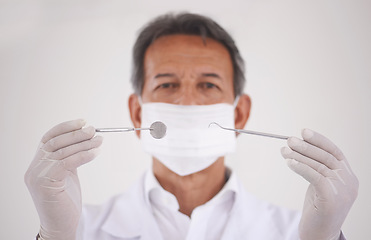 Image showing Portrait, dentist and man with tools, mask and expert advice for orthodontics in medical health. Dental medicine, healthcare and professional with pride, steel equipment and ppe for oral service.