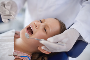 Image showing Crying, child and hands with tools for dental, gum disease and oral hygiene mouth inspection with fear. Dentist, orthodontics and consultation for teeth health, cleaning and wellness with excavator