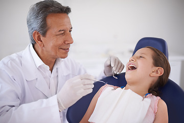 Image showing Girl, child and dentist with tools for healthcare, gum disease and oral hygiene with mouth inspection. Medical, orthodontics and consultation for teeth health, cleaning and wellness with excavator