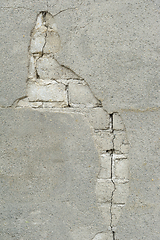 Image showing Close-up view of a wall exhibiting cracking plaster and exposed 