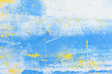 Image showing Abstract blue and yellow paint splatter on a white background