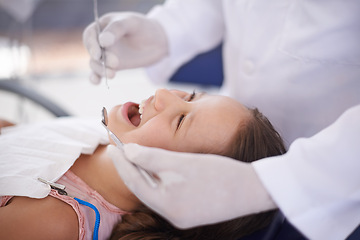 Image showing Girl, child and dentist with tools for healthcare, gum disease and oral hygiene with mouth inspection. Medical, orthodontics and consultation for teeth health, happiness and wellness with excavator