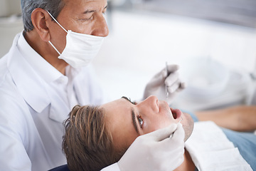 Image showing Dental care, man and dentist with tools for healthcare, gum disease or oral hygiene with mouth inspection. Medical, orthodontics and consultation for teeth health, cleaning or wellness with excavator