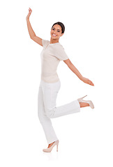 Image showing Woman, winner and celebration in studio for success, winning and achievement with fashion, bonus or sale. Portrait of an excited person with heels, yes and stylish clothes on a white background