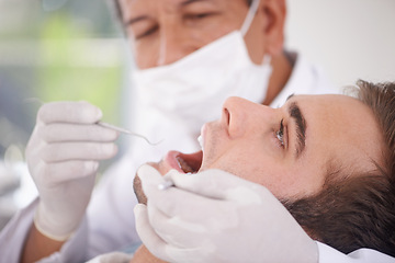 Image showing Dental, man and dentist with tools for healthcare, gum disease and oral hygiene with mouth inspection. Medical, orthodontics and consultation for teeth health, cleaning and wellness with excavator