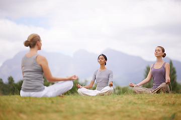 Image showing Lotus, instructor and meditation outdoor for yoga, healthy body and mindfulness exercise to relax. Peace, group and calm women in padmasana in nature for balance, spirituality or breathing together