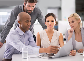 Image showing Business people, documents and paperwork in team discussion for meeting or collaboration at office. Young employees or colleagues brainstorming, reading schedule or planning project at workplace