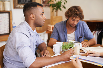 Image showing Man, students and studying in coffee shop with textbook or friends or university education, course or learning. Male people, cup and collaboration in cafe or scholarship or college, degree or exam