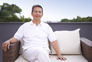 Image showing Outdoor, portrait and man relax on couch of house with smile on face for comfort and sun in patio. Mature person, happy and enjoying nature, outside and home for retirement, senior and elderly