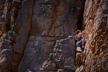 Image showing Woman, mountain climbing and outdoors for adventure, fitness and exercise in the sun for extreme sports. Female person, rock workout and nature for wellness, risk and fearless activity for strength