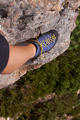 Image showing Closeup, leg or shoe for rock climbing, fitness or nature for health, adventure or outdoor activity. Mountain climber, cliff and trees for healthy exercise, sports and leisure in Puerto Rico