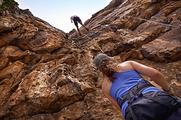 Image showing Friends, rope and mountain for rock climbing, safety and adventure on weekend getaway with bonding. Partner with people, outdoor and gear for protection with sports, fitness and exercise in nature