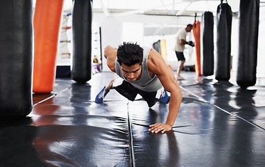 Image showing Man, pushups and training for fitness, sport and health for being a boxer on mat with one arm. Male person, wellness and exercise for workout, athlete and cardio strength for commitment in boxing gym