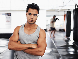 Image showing Exercise, training and portrait of man in gym for sport, practice or wellness for health. Personal trainer, face and serious expression with arms crossed for confidence, fight skill or development