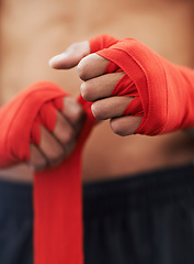 Image showing Closeup, hand and wrap for mma, protection and strength at fitness and workout studio in Thailand. Strap, fist and fingers to bandage and protect for exercise, training and competitive fighting