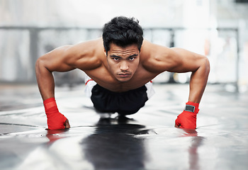 Image showing Fighter, portrait and push ups for sports in gym for training, wellness and workout for body. Man, exercise and gloves on fists, muscle and health for person in fitness centre, strong and serious