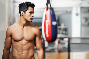 Image showing Boxing, training and man in gym for exercise, practice and fitness for health. Personal trainer, serious expression and thinking with confidence for workout, planning and vision with shirtless body