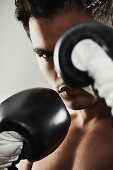 Image showing Portrait, man and boxer in training, sports or workout in stance for body health isolated on a gray background in studio. Fight, serious face and athlete in gloves for fitness, exercise and match