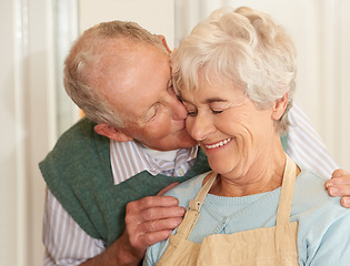 Image showing Senior couple, romance and kiss at home, smile and bonding together in retirement. Elderly people, love and happy in marriage or relationship, weekend and support in commitment or care in kitchen