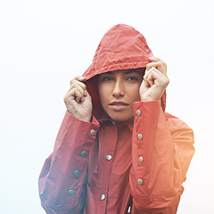 Image showing Woman, portrait and raincoat with hood for weather, cloudy sky or winter season in outdoor storm. Face of female person or model with red waterproof rain jacket for cold overcast or fog on mockup
