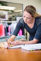 Image showing Fashion, designer and drawing for style, design and creativity at desk in boutique with mockup. Creative, female person or clothes with fashionable, sketch and fabric with artistic inspiration