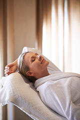 Image showing Woman, massage bed and calm in spa for peace of mind, wellness and luxury for self care and body detox. Female person, relax and smile for stress relief with eyes closed, treatment and break for zen