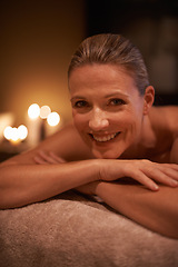 Image showing Female person, smile and spa for wellness, relax and self care and massage on table being happy. Woman, body treatment and portrait to destress, peace and detox for calm and holistic relaxation
