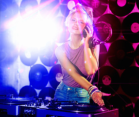 Image showing Portrait, woman dj and headphones for retro, nightclub and party with neon lights and lens flare. Happy gen z person, listen and mixing tracks and vinyl at rave or techno music event in Berlin disco