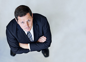 Image showing Crossed arms, top view and serious businessman in office with positive, good and confident attitude. Portrait, professional and high angle of male lawyer with pride for legal career in workplace.