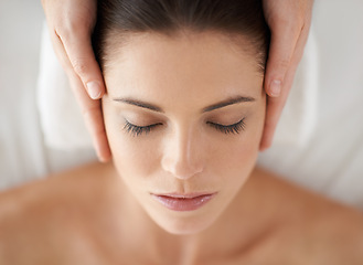 Image showing Hands, above and facial massage of woman at spa to relax, peace and calm at luxury resort with masseuse. Top view, therapy and person at salon for face treatment, skincare and beauty for wellness