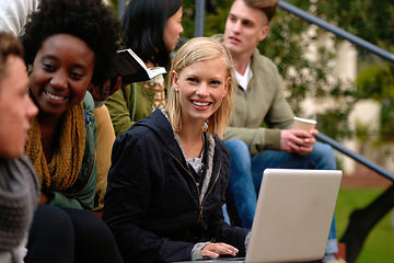 Image showing Woman, university student with laptop and outdoor on campus, smile and research to study for exams. Diverse group, college and information for learning and share notes for test or assignment deadline