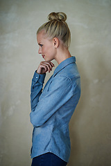 Image showing Young woman, thinking and casual fashion on a beige wall background at home for idea. Vision, profile and female person with style and apparel while relaxing in her house and planning trendy clothing