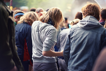 Image showing Woman, crowd and dance at concert in summer for event, festival and entertainment outdoors. Community, celebration and friends at party with audience for sound, energy and live music in nature