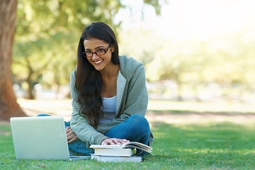 Image showing Laptop, student or happy woman in nature reading book for learning knowledge, information or education. Research, textbook or person in park on grass for studying or typing online on college campus