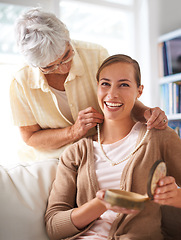 Image showing Elderly mother, necklace and portrait of woman with present, gift and surprise in living room. Family, love and happy daughter with mom giving pearls on sofa for celebration, birthday and bonding