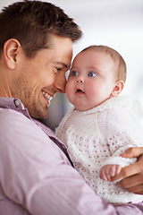 Image showing Father, hug and baby with love, support and care for family, bonding and paternity at home. Happy dad, parent or man playing with his newborn child for affection, development and excited for growth