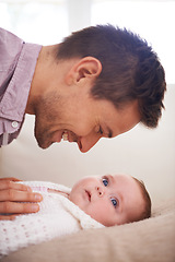 Image showing Father, playing and newborn baby on bed with love, support and care for family, paternity and bonding. Excited dad, man or parent with his child or kid for development, growth and nurture at home