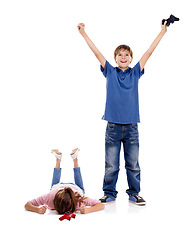 Image showing Happy, sad and children with video games on a white background for playing, celebration and winning. Family, siblings and upset girl with excited boy with remote controller for gaming in studio