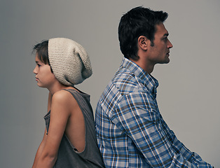 Image showing Father, son and back in disagreement, argument or ignore with fashion on a gray studio background. Profile of dad, kid or young child in casual clothing, conflict or fight for parenthood or childhood