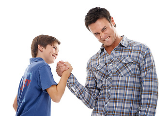 Image showing Father, portrait and arm wrestle with child for game of strength, power or playful bonding on a white studio background. Dad, son or kid with handshake in battle for challenge, parenting or childhood