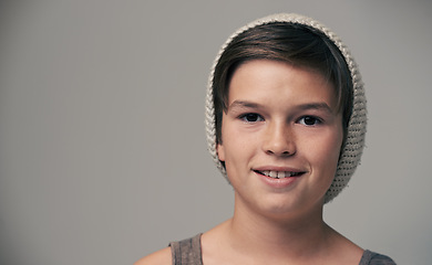 Image showing Boy, kid and beanie in studio for portrait with smile, mockup and space for fashion by background. Child, model and hat with trendy style, happy and pride for clothes with confidence for punk outfit